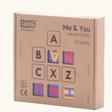 Bajo me & you alphabet blocks. Set of 12 wooden 4cm cube blocks with letters on each side in their box.
