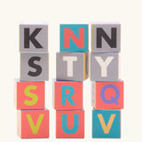 Bajo me & you alphabet blocks. Set of 12 wooden 4cm cube blocks with letters on each side.