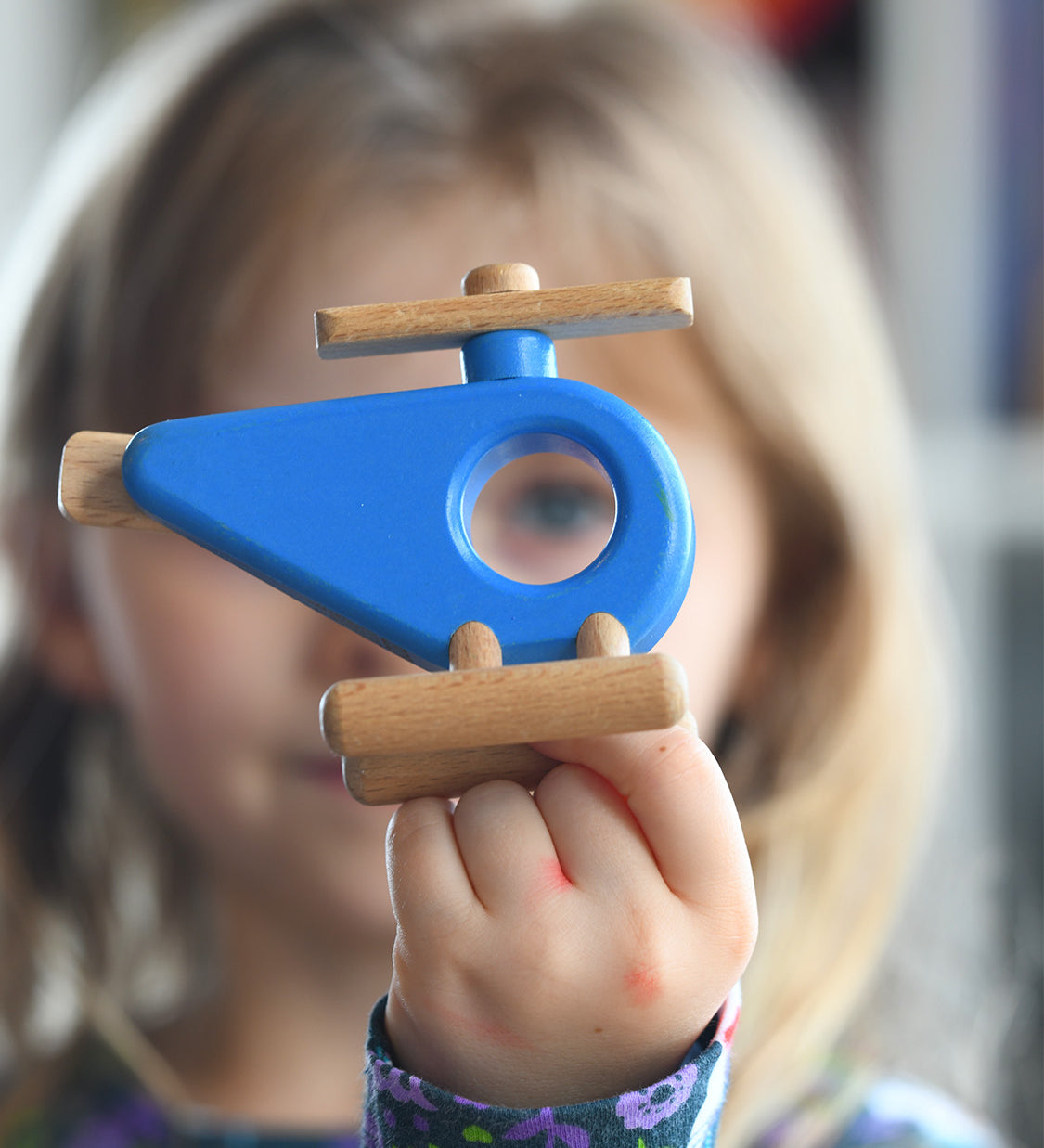 Child holding the Bajo Helicopter in Blue