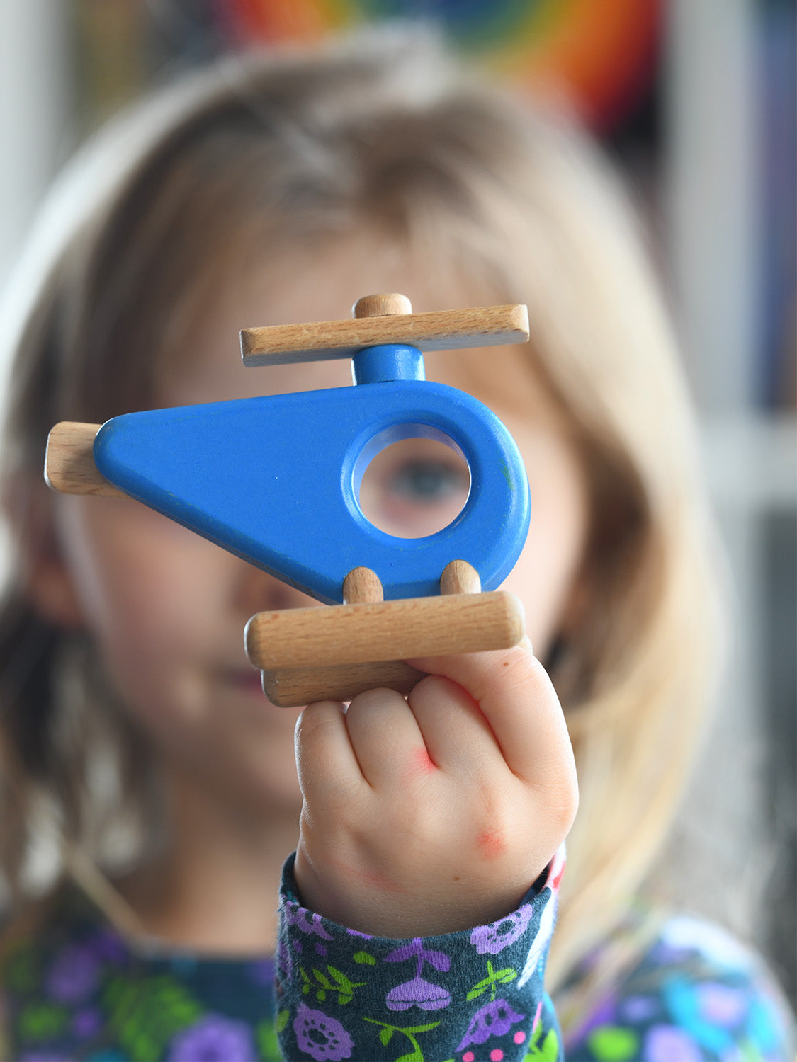 Child holding the Bajo Helicopter in Blue