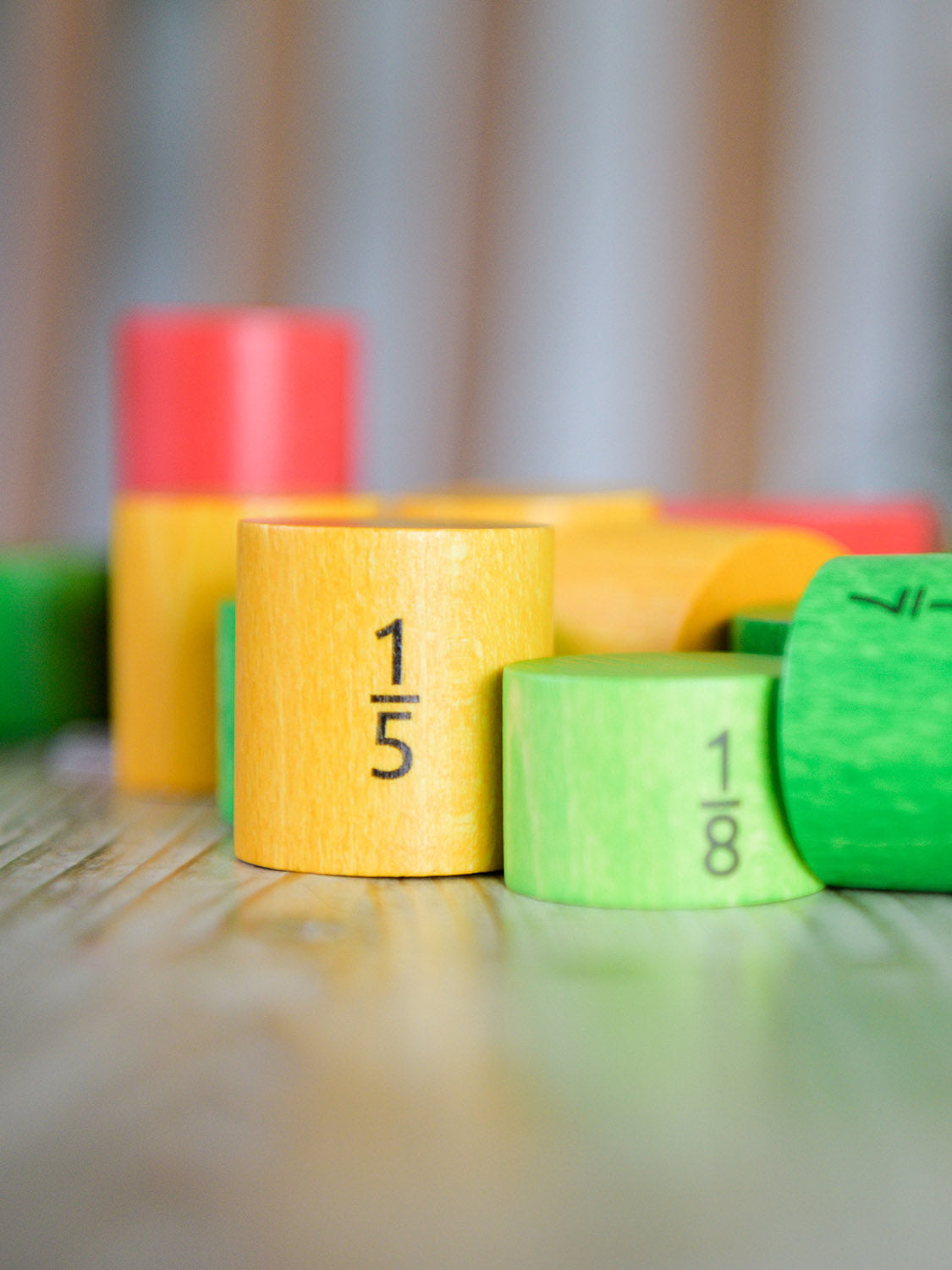 Bajo Fraction Set Maths Resource Learning Toy showing wooden Bajo fraction blocks in yellow 1/5