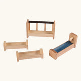 Beck Holzspielzeug wooden barn accessories including feeding manger, two feeding troughs, blue water trough with pump, and natural wood farm pieces.
