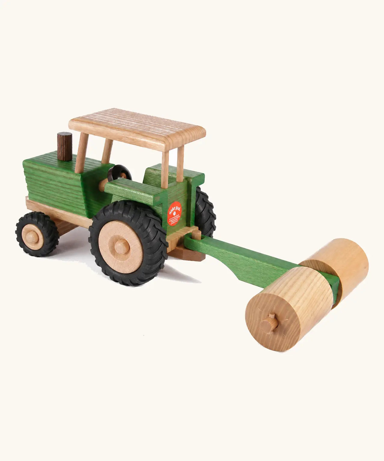 Beck Holzspielzeug traditional wooden toy tractor pulling farm roller attachment, with Spiel Gut award sticker on the back. 
