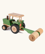 Beck Holzspielzeug traditional wooden toy tractor pulling farm roller attachment, with Spiel Gut award sticker on the back. 