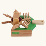 Underside of Beck Holzspielzeug wooden hay tedder toy tractor attachment, showing functional spinning elements.