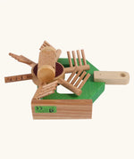 Underside of Beck Holzspielzeug wooden hay tedder toy tractor attachment, showing functional spinning elements.