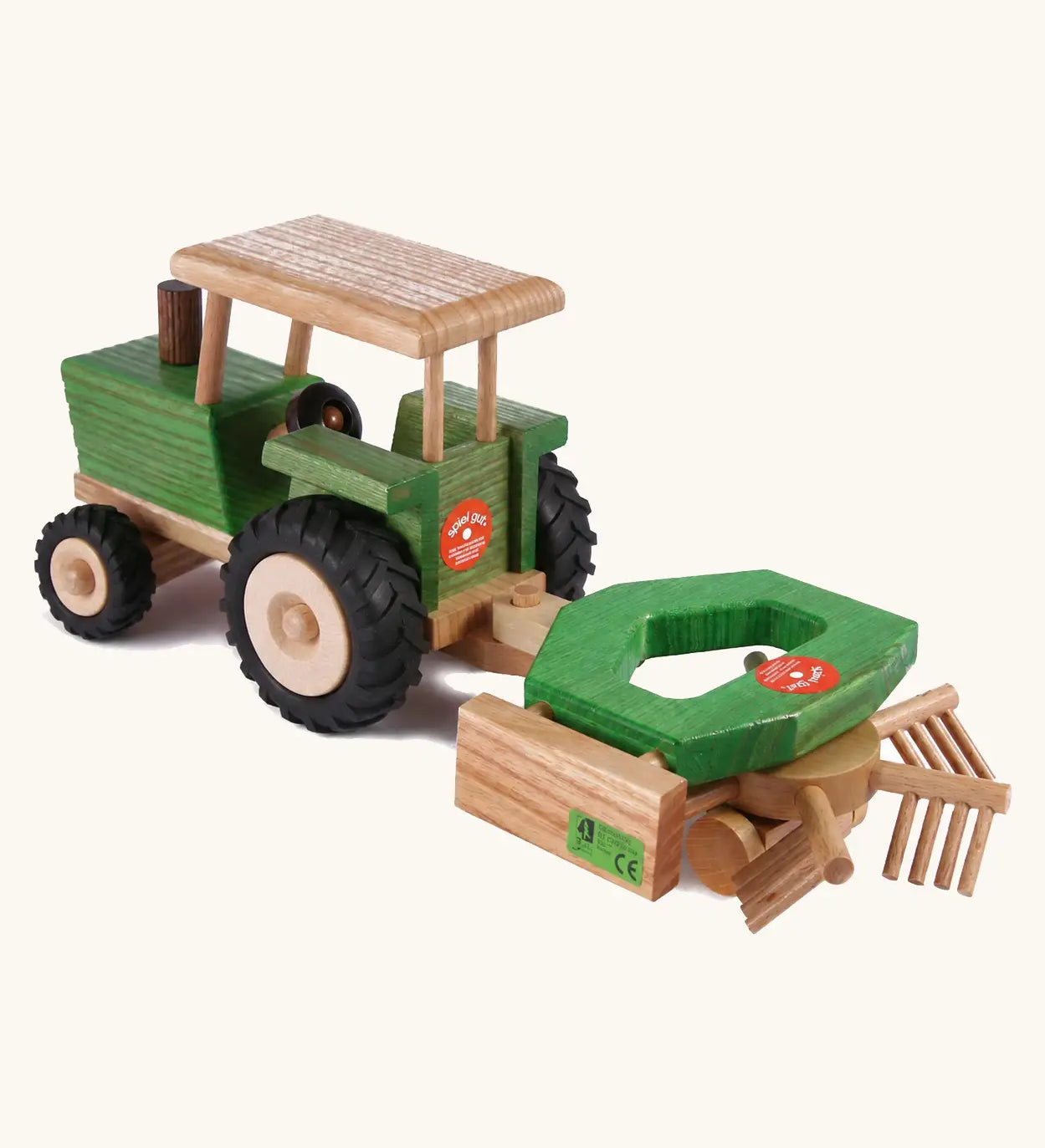 Beck Holzspielzeug wooden toy tractor pulling hay tedder attachment toy for realistic small-world farm play.