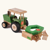Beck Holzspielzeug wooden toy tractor pulling hay tedder attachment toy for realistic small-world farm play.