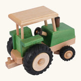 Side of Beck Holzspielzeug steerable wooden toy tractor, showing natural wood  grain, green stained body, and chunky rubber wheels.