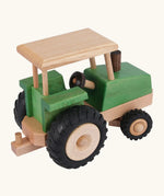 Side of Beck Holzspielzeug steerable wooden toy tractor, showing natural wood  grain, green stained body, and chunky rubber wheels.
