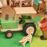 Beck Holzspielzeug traditional wooden toy tractor in small-world farm play scene with Ostheimer people and animal figures.