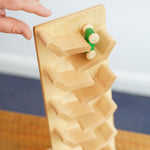 A view from above of a green coloured racing car being placed onto the Beck Toys Cascading Tower Run Track .