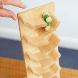 A view from above of a green coloured racing car being placed onto the Beck Toys Cascading Tower Run Track .