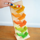 The wooden millipede car train being placed on the Beck Toys Beechwood Cascading Tower Running Track.