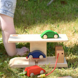 Beck wooden garage & petrol station with toy card placed on the ramp and on the roof.