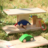 Beck wooden garage & petrol station with a blue wooden toy car placed on the ramp.