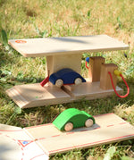 Beck wooden garage & petrol station with a blue wooden toy car placed on the ramp.