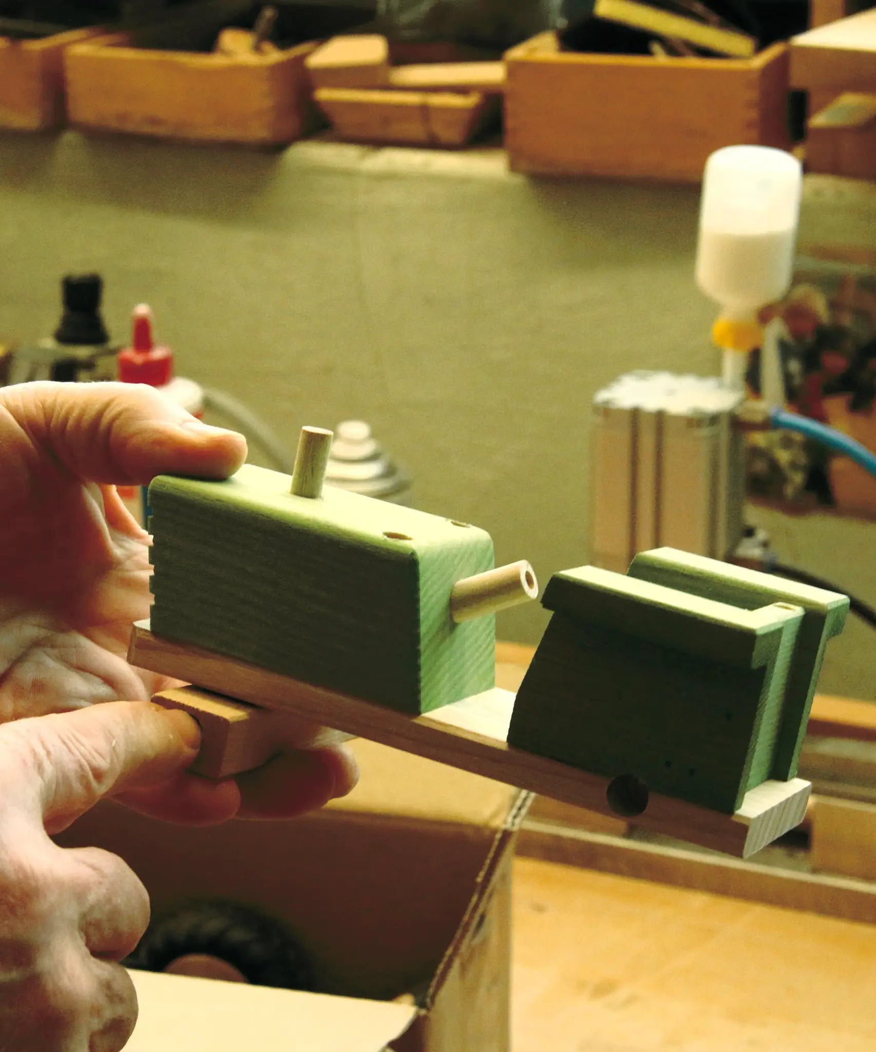 Artisan toymaker in the process of hand making the Beck wooden toy tractor in their German workshop.