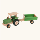 Beck green wooden tractor with a working steering wheel and black rubber tyres with a trailer hitched on the back