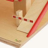 A close up of the barrier on the bottom of the ramp on the Beck Holzspielzeug Wooden Multi-Storey Car Park for Toy Cars. This wooden toy car park is part of a wide range of toy vehicles and accessories available at Babipur.