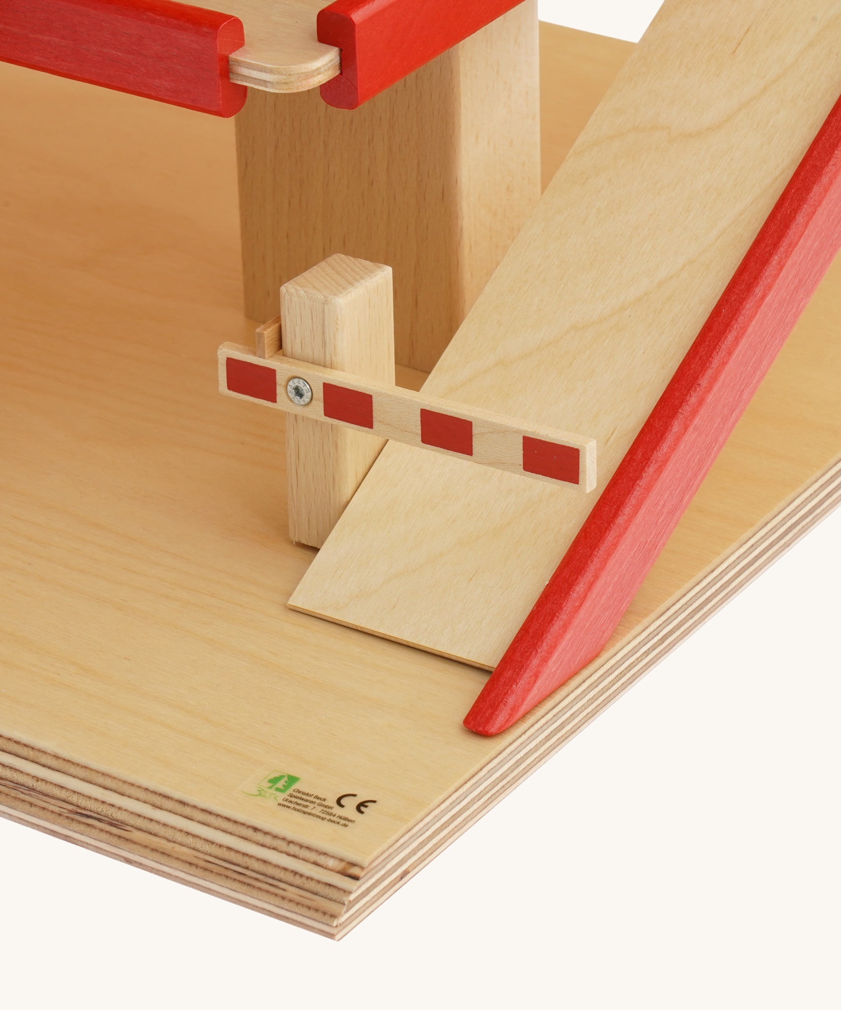 A close up of the barrier on the bottom of the ramp on the Beck Holzspielzeug Wooden Multi-Storey Car Park for Toy Cars. This wooden toy car park is part of a wide range of toy vehicles and accessories available at Babipur.