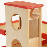 A close up of the wooden knob that operates the lift on the Beck Holzspielzeug Wooden Multi-Storey Car Park for Toy Cars. This wooden toy car park is part of a wide range of toy vehicles and accessories available at Babipur.