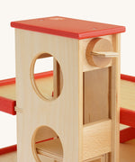 A close up of the wooden knob that operates the lift on the Beck Holzspielzeug Wooden Multi-Storey Car Park for Toy Cars. This wooden toy car park is part of a wide range of toy vehicles and accessories available at Babipur.