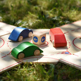 Close up of the Beck wooden roundabout junction set with toy cars placed on the roundabout.