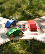 Close up of the Beck wooden roundabout junction set with toy cars placed on the roundabout.