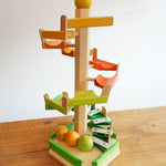 A Beck Toys Beechwood Step Tower with Glockenspiel Chimes placed on a wooden surface.