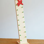 Beck wooden Toys Wobbler with Red Person Figure placed on a wooden surface. 