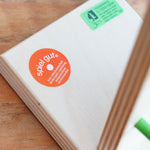 A close up of the Spiel Gut certification sticker on the Beck wooden Toys Wobbler Toy.