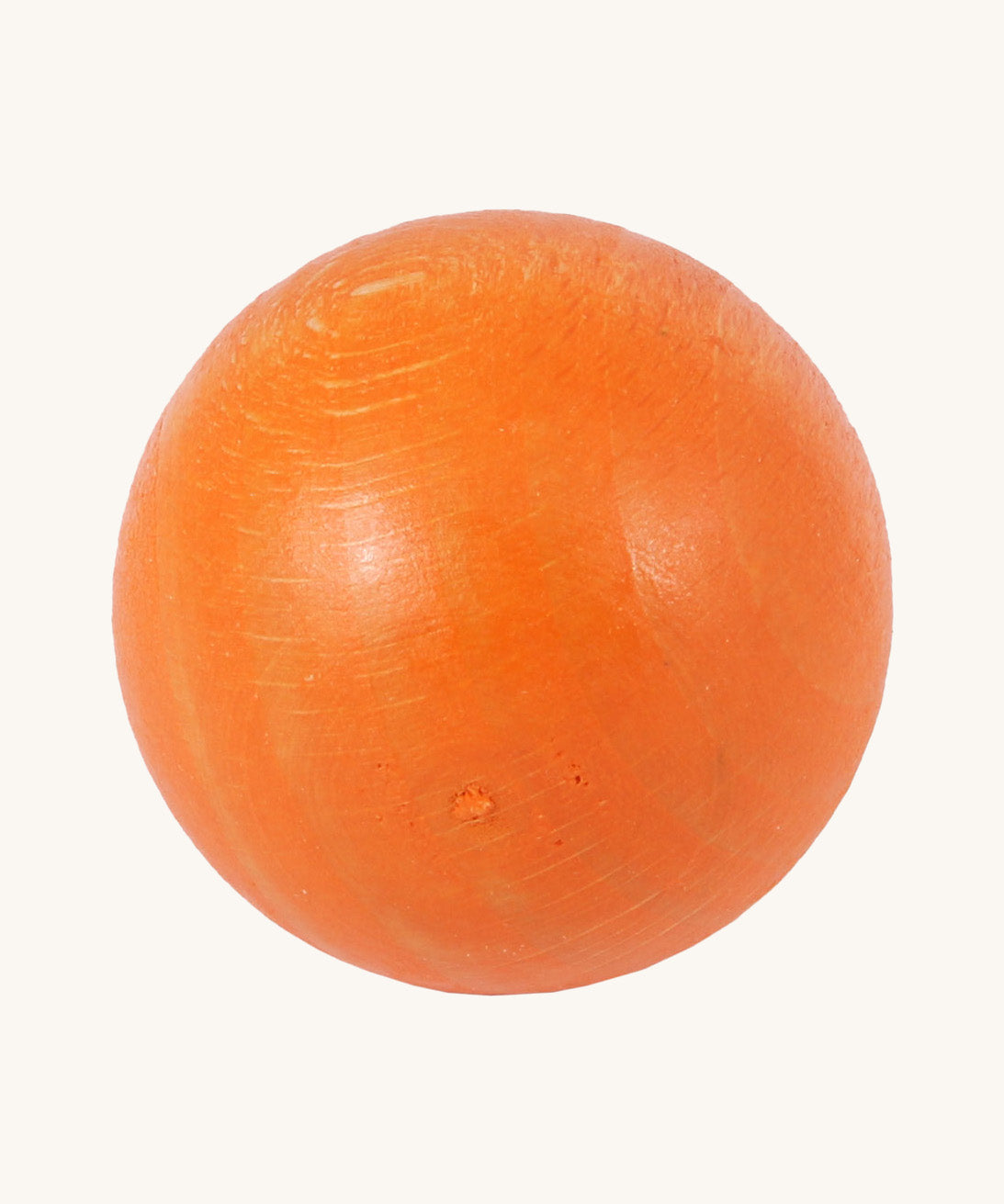 A close up of the orange ball from the Beck Toys wooden ball set