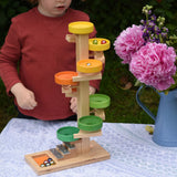 A child observing the glass marbles twirling down the Beck Toys Beech Wood Plate Tower Marble Run with Glockenspiel. 