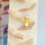A close up of a yellow coloured racing car on it's way down the Beck Toys Cascading Tower Run Track.