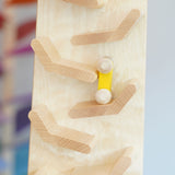 A close up of a yellow coloured racing car on it's way down the Beck Toys Cascading Tower Run Track.