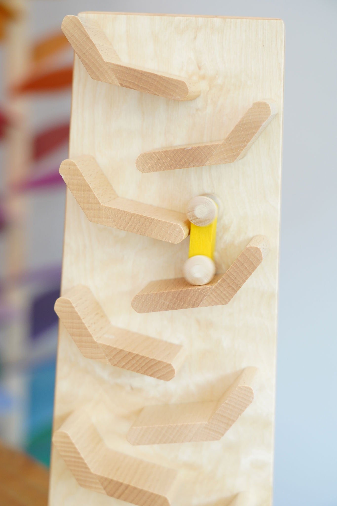 A close up of a yellow coloured racing car on it's way down the Beck Toys Cascading Tower Run Track.
