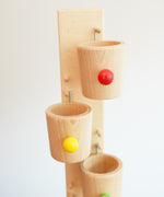 A close up of one of the wooden cups on the Beck Toys Beech Wood Roller Cup Marble Run.
