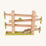 Beck Toys musical run track, a wooden toy crafted from beech wood, featuring four wooden ramp tracks with small green planks as stoppers and glockenspiel notes to finish with a green ball travelling down