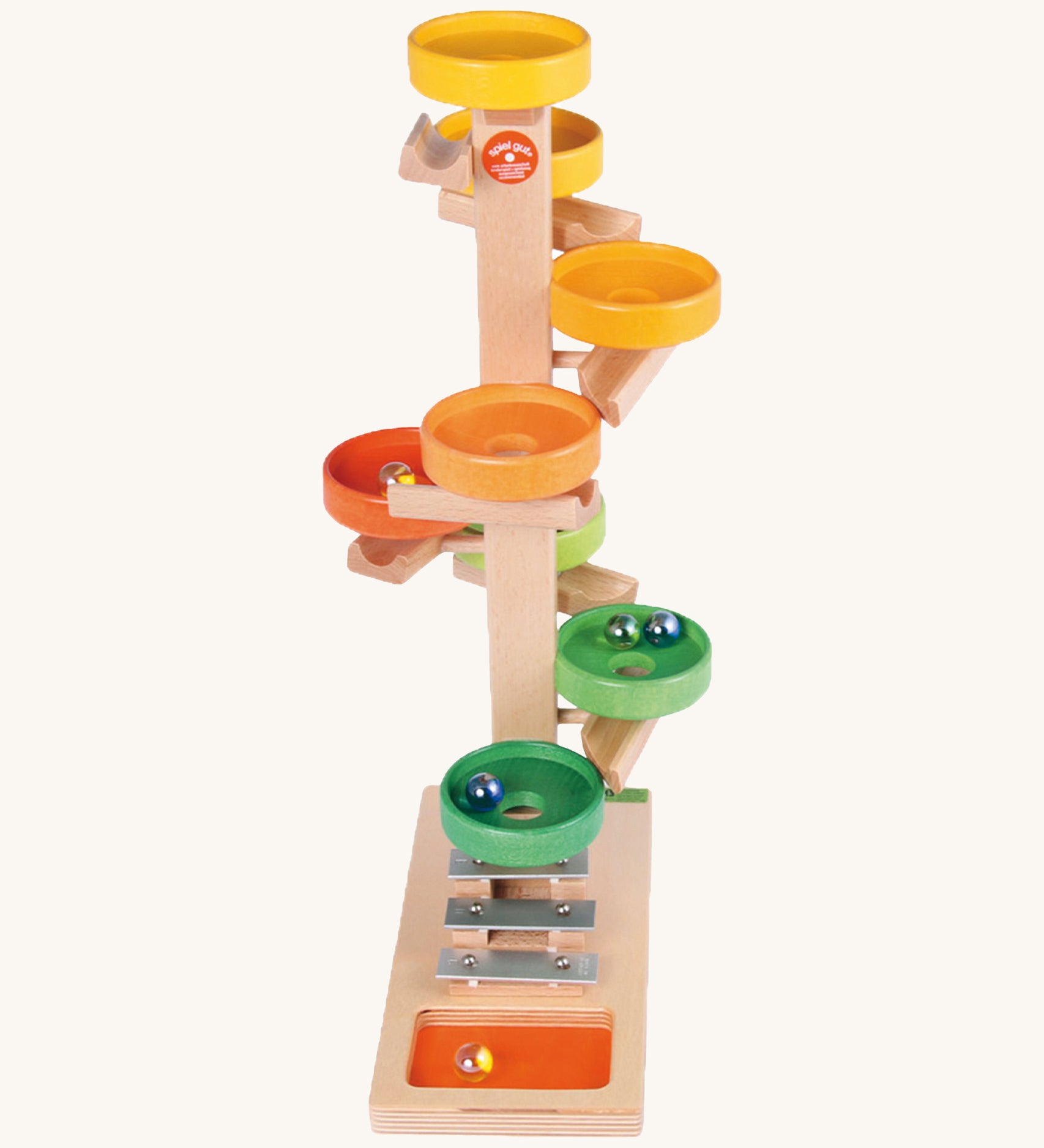 Beck Toys wooden tower marble run. Made from beech wood showing a series of coloured plates and a glockenspiel on the bottom. 