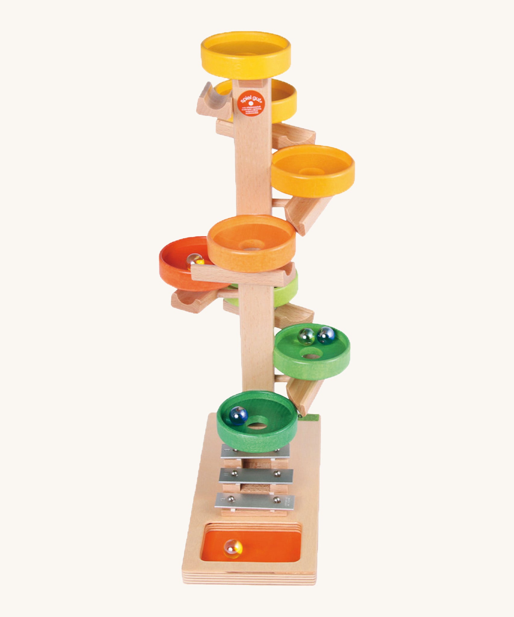 Beck Toys wooden tower marble run. Made from beech wood showing a series of coloured plates and a glockenspiel on the bottom. 