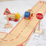 Beck wooden road pieces with a stop and working traffic sign standing near 