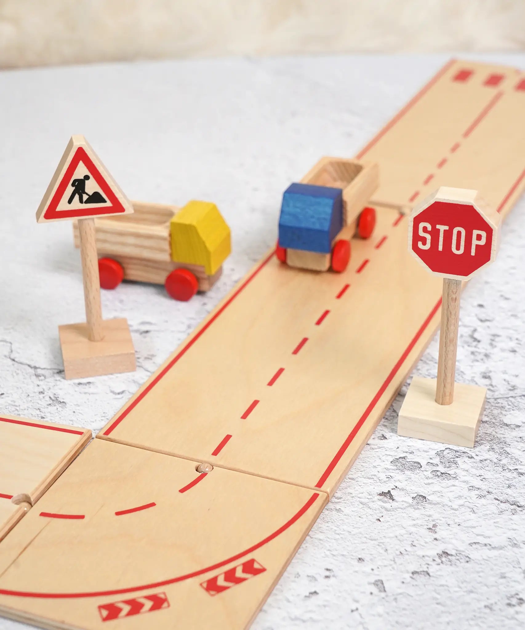 Beck wooden road pieces with a stop and working traffic sign standing near 