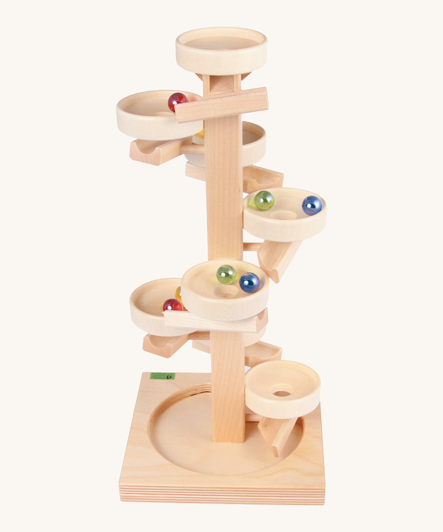 Beck Toys wooden tower marble run. Made from beech wood showing a series of plates along the stand and marbles travelling down