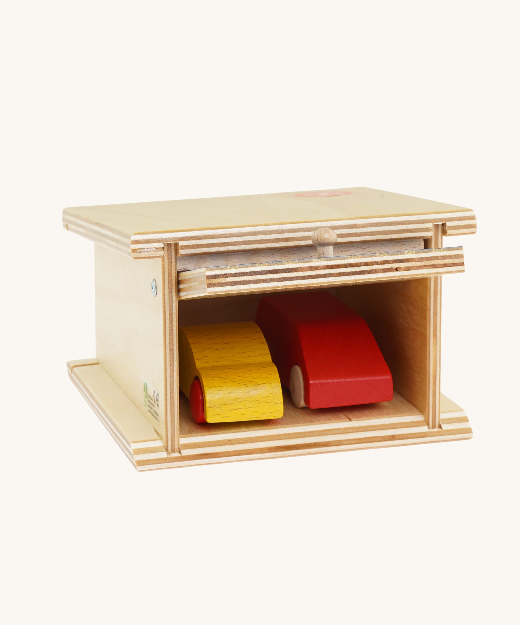 A Beck Holzspielzeug Wooden Small Toy Car Garage with two wooden cars inside. This wooden toy car garage is part of a wide range of toy vehicles and accessories available at Babipur.