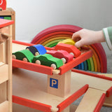 A collection of Beck wooden vehicle toys parked on the top level of the multi-storey car park. Beck have a range of wooden toys and ball runs available at Babipur. 