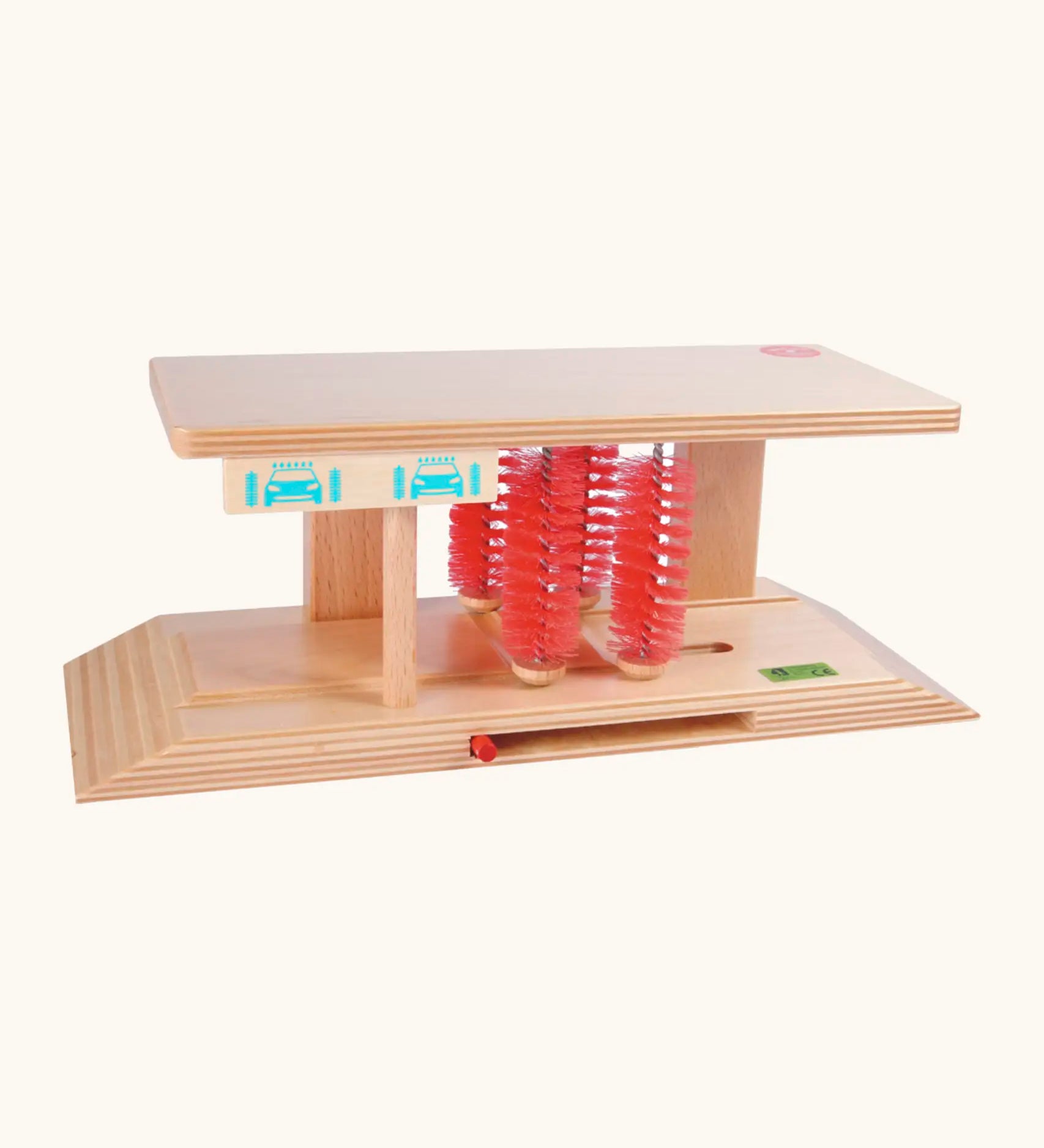 Beck wooden car wash toy showing a ramp on each end with red bristles in the middle and a handle to move the bristles