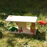 Beck wooden garage & petrol station with wooden toy cars and van placed around it in a simple small world play set up.