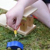 fueling hose from the Beck wooden garage & petrol station in a child's hand.