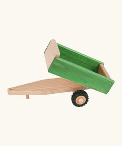 Beck wooden green tipper style trailer with a hitch for a tractor and black rubber wheels 